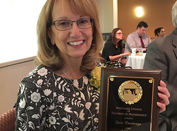 Derenberger holding plaque for award: Maryland Council of Mathematics