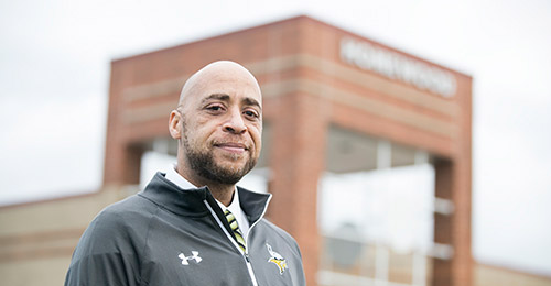 Photo of Anthony Bell in front of Homewood Center building