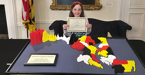 Student displaying her LEGO map.