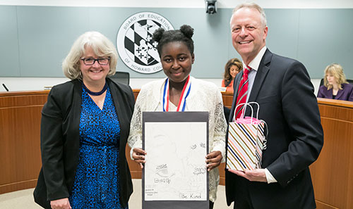 Christina Ogunsola standing with Board Chairman Cynthia Vaillancourt and Dr. Michael J. Martirano