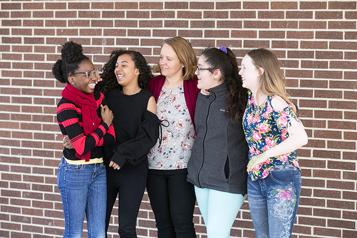 Principal Chrobak with her students outside the school building.