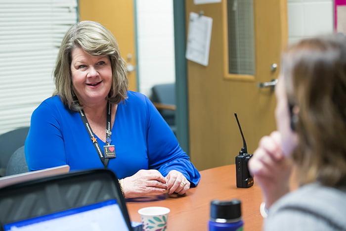 Suzanne McMurtray working with fellow staff.