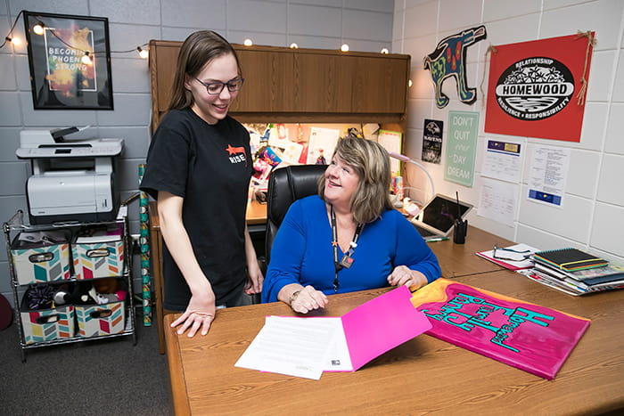 Suzanne McMurtray in her office working with a student.