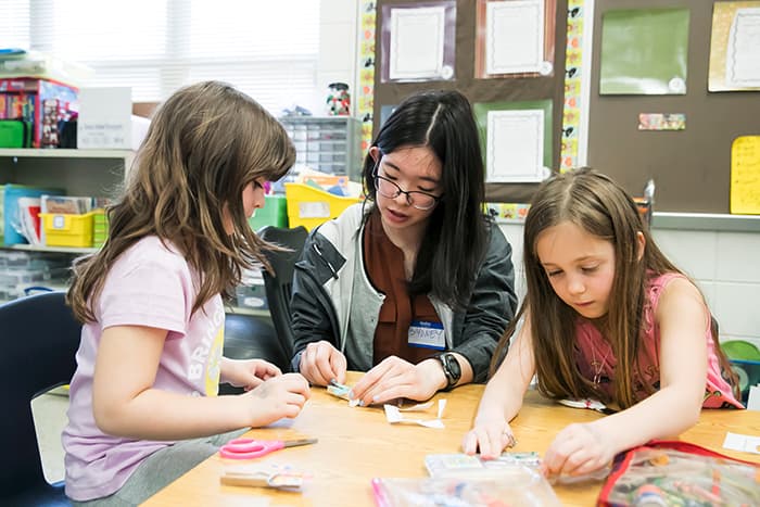 Three girls working collaboratively.