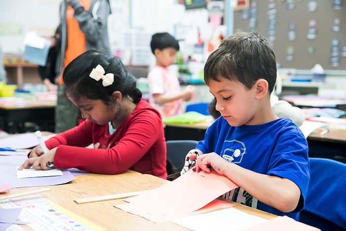 Two children making a craft.