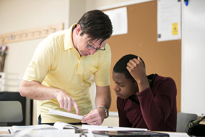 Keith Artley working teaching measurement to a student.