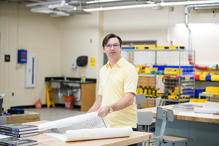 Keith Artley standing in the workshop.