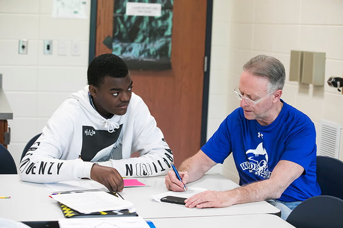 Dr Martirano working in class with Tariq.