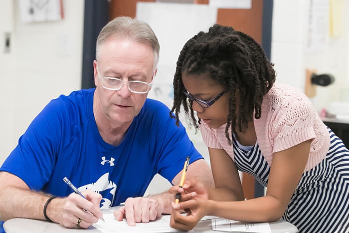 Dr Martirano working in class with Raquel.