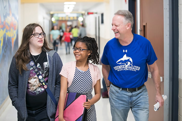 Dr Martirano walking with Raquel and another student.