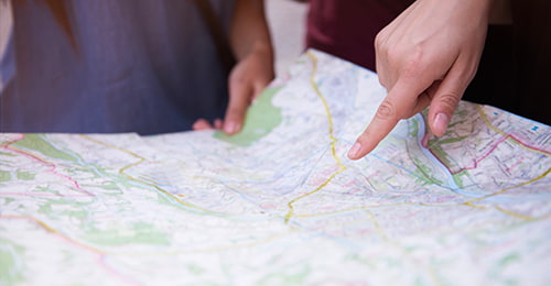 fingers pointing on a paper map