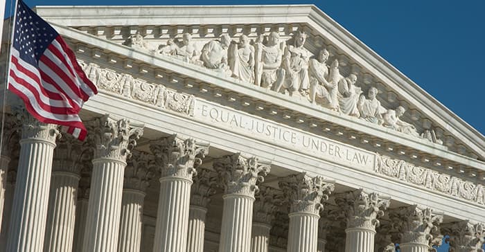 A flag is flying in front of a court building.