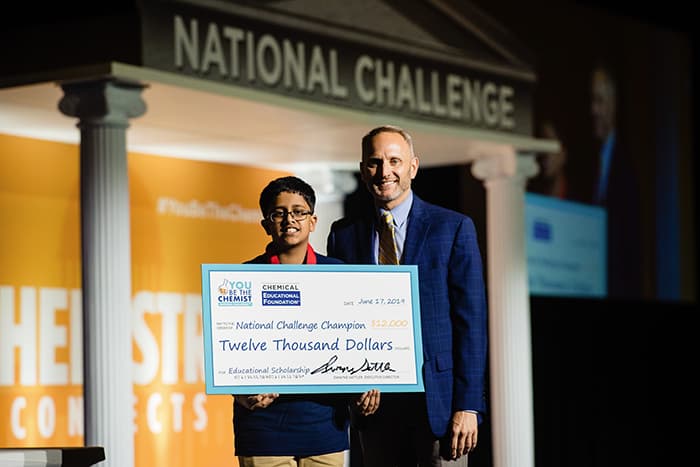 You Be the Chemist Challenge Winner Anurag Sodhi holds a check for $12,000.