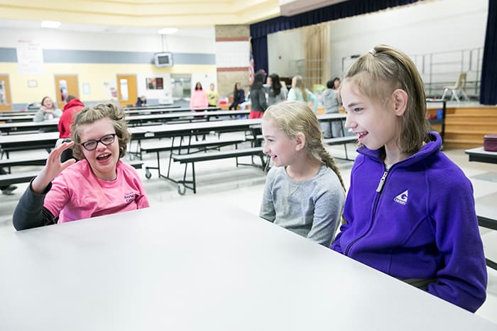 Three female students in the Folly Quarter Middle School cafeteria.