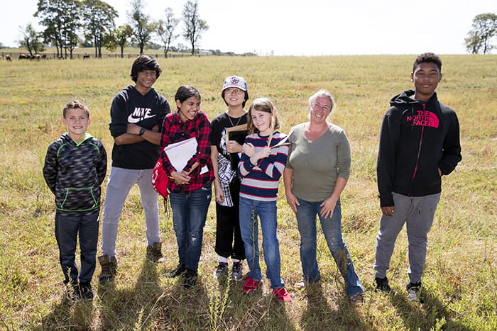 A group of Harper's Choice Middle School students in a field.