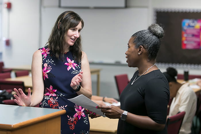 Sandy Saval speaks with an HCPSS HR colleague.