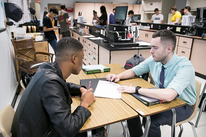 David Klotz works with an African-American male student.
