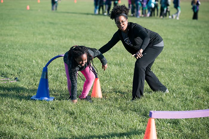 A mother and daughter playing games on a field.