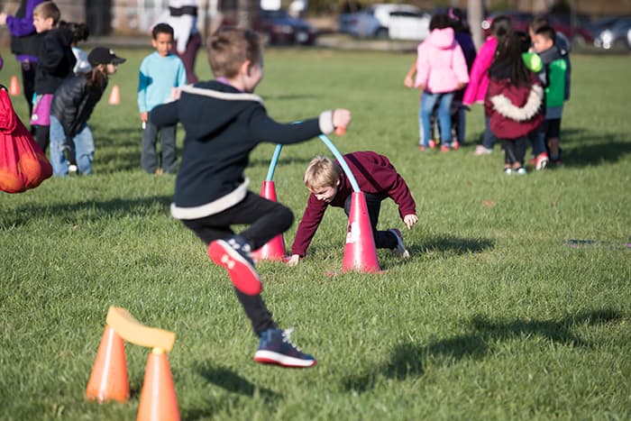 Children playing games on a field.