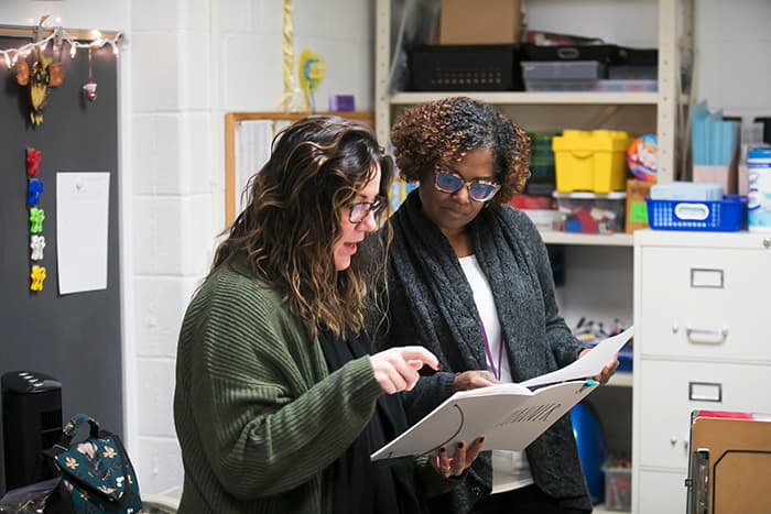 Clara Hendrick working with a staff member.