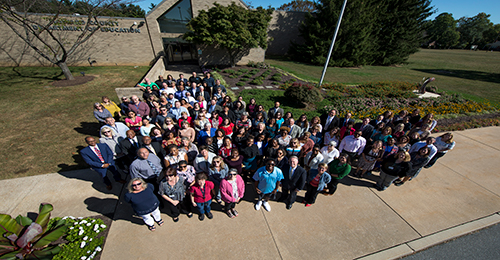 HCPSS Office Staff standing outside the Board of Education building.