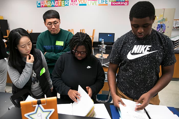 South Korean science teachers observing students.