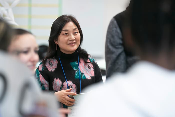 Smiling female South Korean science teacher.