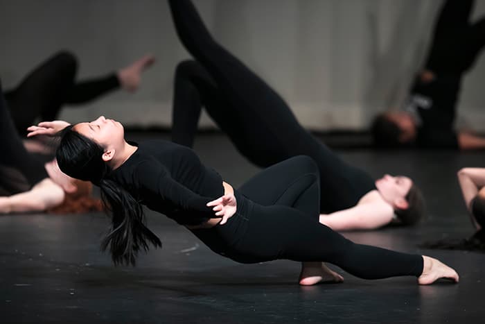 A female dancer suspended in air.