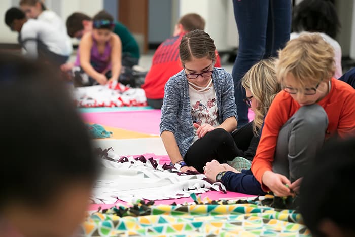 Students making blankets.