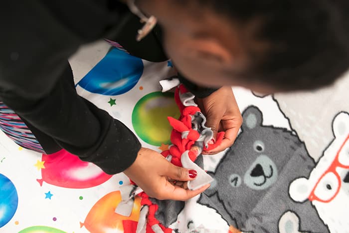 A student making a blanket.