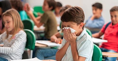 Male student sneezing.