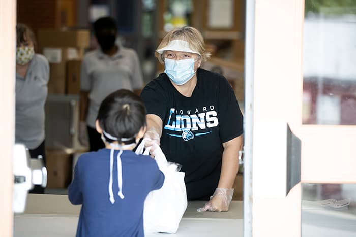 Kristin Rhodes serves a student food.