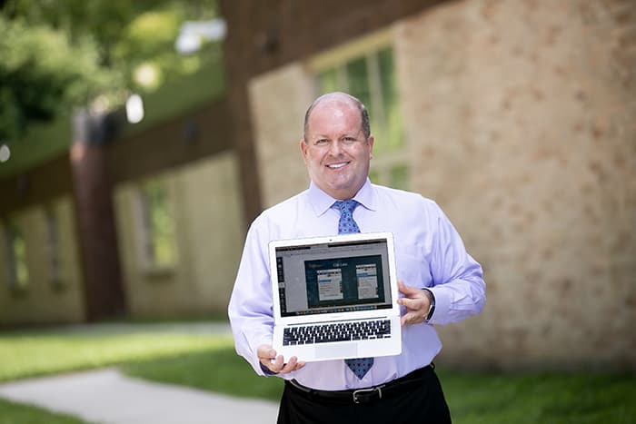 A man holding a laptop.