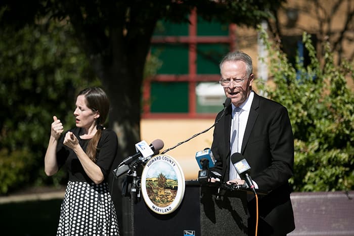 Dr. Martirano speaking at a podium next to a sign interpreter.