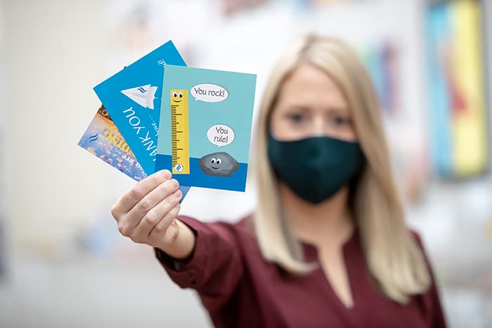 Allison Whitney holding a stack of cards.