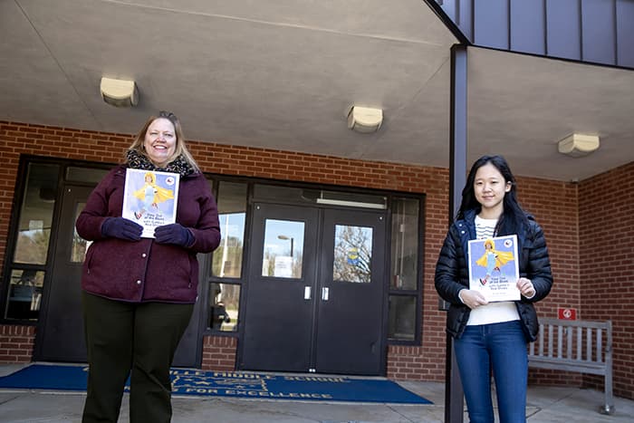 Olivia Shim and Carol Van Gorp holding copies of Olivia Shim holding Step out of the Blues with Gabby’s Red Shoes.