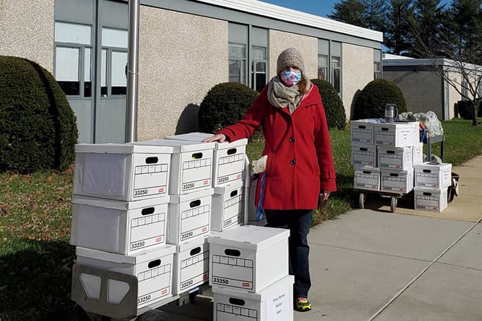 Biotech teacher distributing science kits outside ARL.