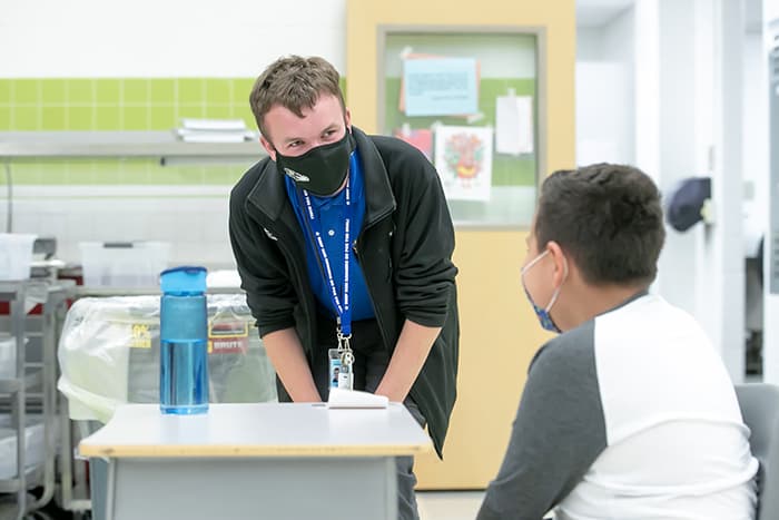 Bradley Wilson speaking to a male student.