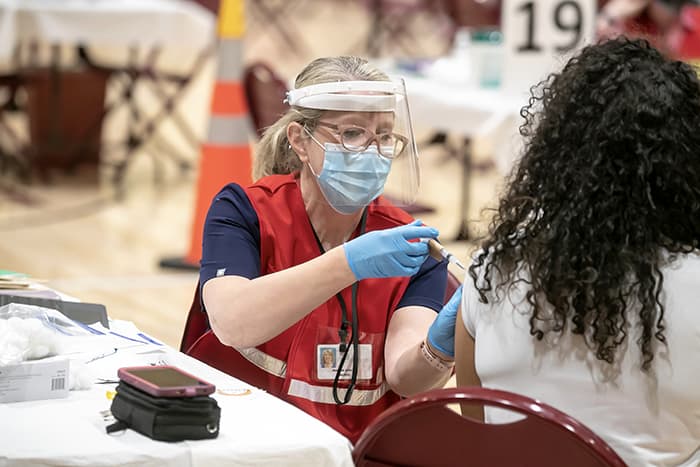 An HCPSS nurse administering a COVID vaccine.