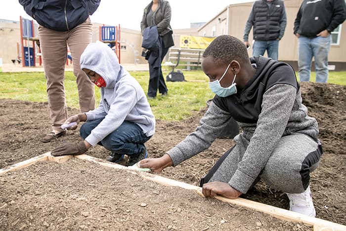 Students planting a garden.