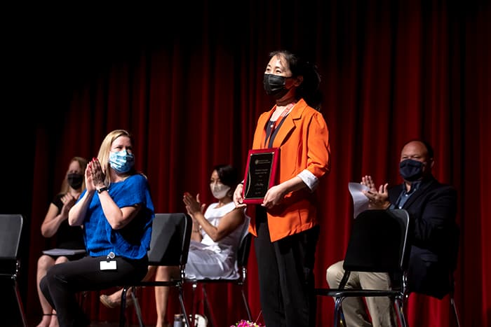 Hui Liang receiving the Maryland Language Teacher of the Year award.