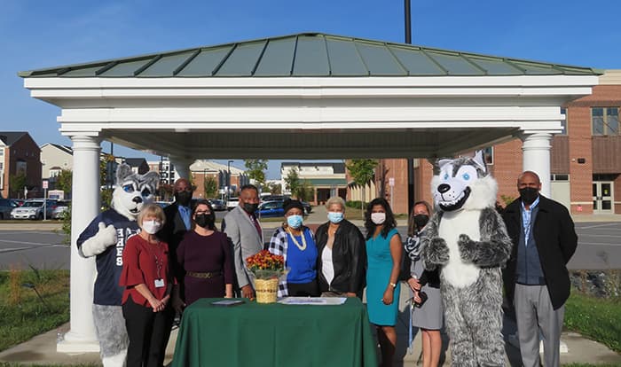 Representatives from Hanover Hills Elementary School, Thomas Viaduct Middle School, and the First Baptist Church of Elkridge pose with HHES and TVMS mascots.