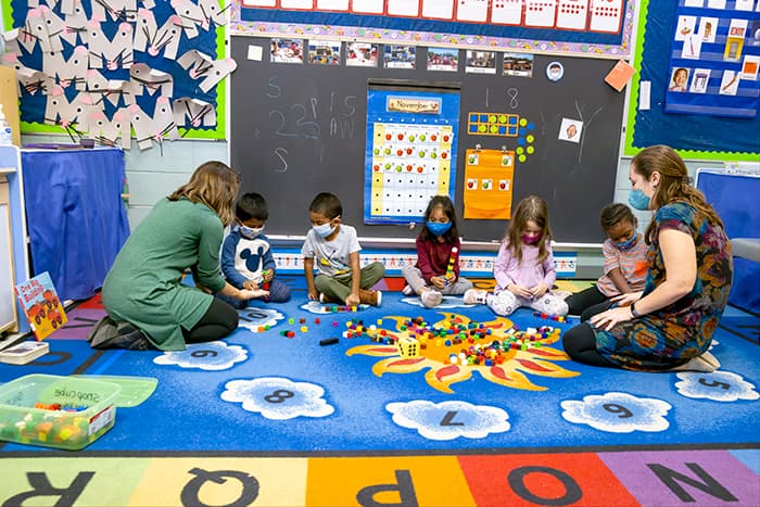 VES Pre-K teachers Lea Clink and Casey Beaucage work with students on building blocks.