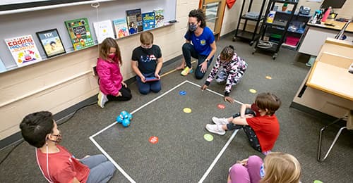 Clemens Crossing ES students use iPads to program robots to move around in a defined space.