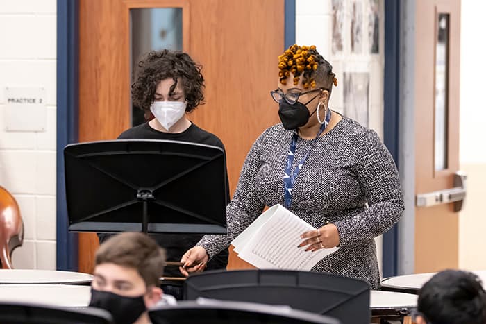 WLMS band director Tiffany Walker works with a student playing percussion.