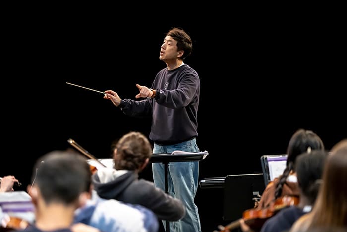 Jay Kim conducts the RHHS orchestra.