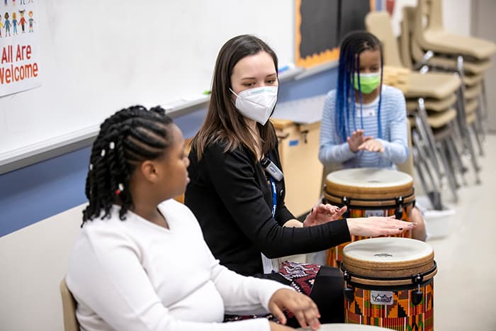 LOES music teacher Alicia Wetmore shows students how to use a drum.