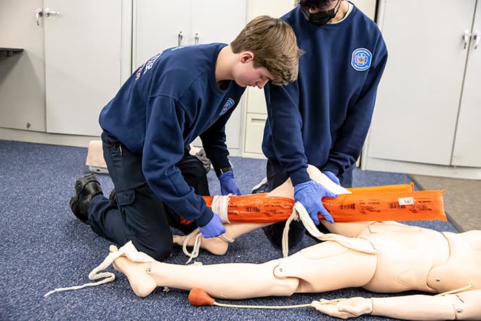 EMT student Ben Gallagher learns how to splint a leg on a mannequin.