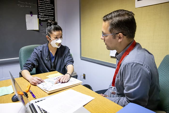 Mei-Ling Chen and David Alianiello discuss an audiology report.