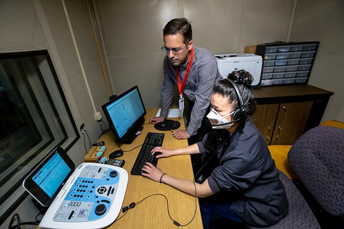 Mei-Ling Chen and David Alianiello use audiology technology.